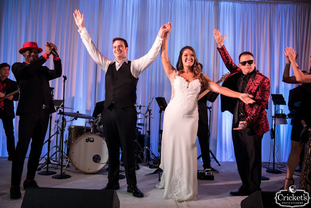 Brida and groom standing on band stage