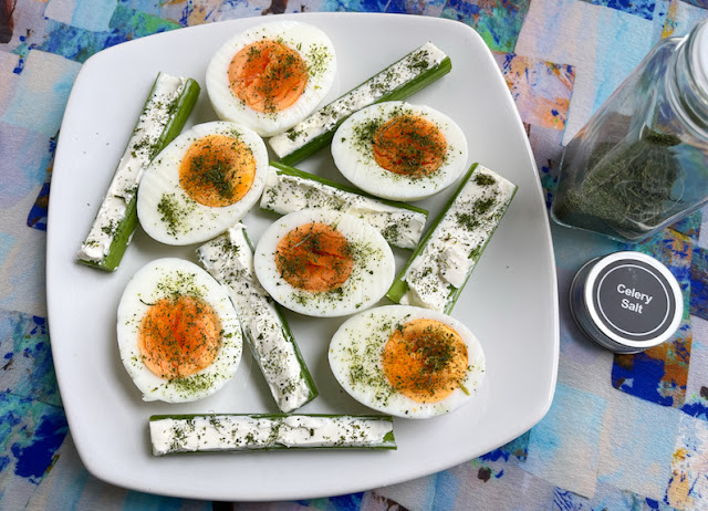 Homemade celery salt on eggs and cream cheese stuffed celery sticks