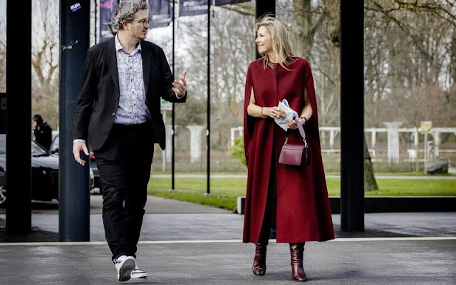 Queen Maxima wore a wool and cashmere-blend cape by Valentino. Wandler Georgia wine shoulder bag. Gianvito Rossi Laura boots