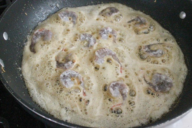 Adding the prawns to the hot oil