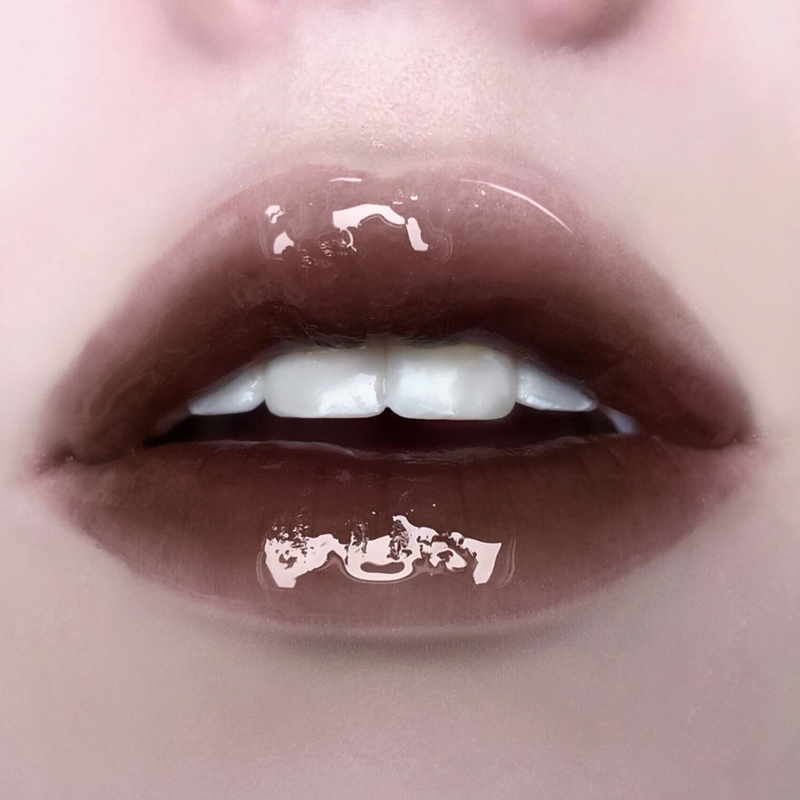 close up of a plump women lips with an aesthetic gradient brown lip look and glossy finish