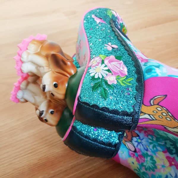 close up of dog heels on green glitter shoes