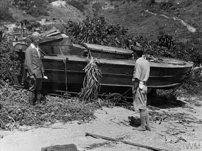 Japanese suicide boat pilots with their craft after the destroyers Whirlwind and Quadrant seized their base in Picnic Bay near Hong Kong between August and September 1945