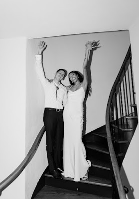 bride and groom smiling on stairs