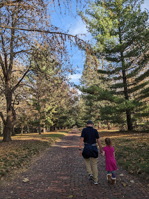 Walking the brick path through the many trees at Nebraska's Arbor Lodge State Historic Park