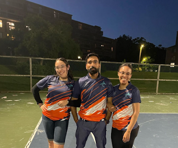 Faxon Commons staff with resident at tennis court wear tennis tournament shirts