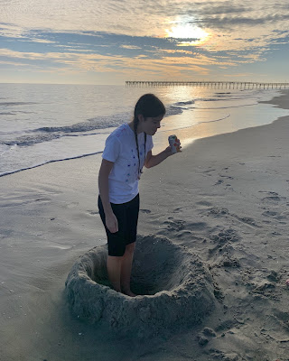 You in your sand hole about to spit out the seltzer in your mouth because you are laughing at something.