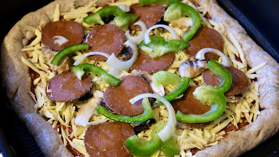 Vegan pepperoni, green pepper, mushroom and onion pizza before going in the oven