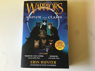 book cover of Warriors: Enter The Clans featuring dark blue covering with new moon and several cats gathered around a rock