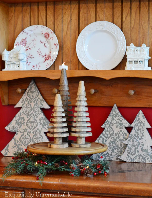 Three Decoupage Christmas Trees on a dresser with