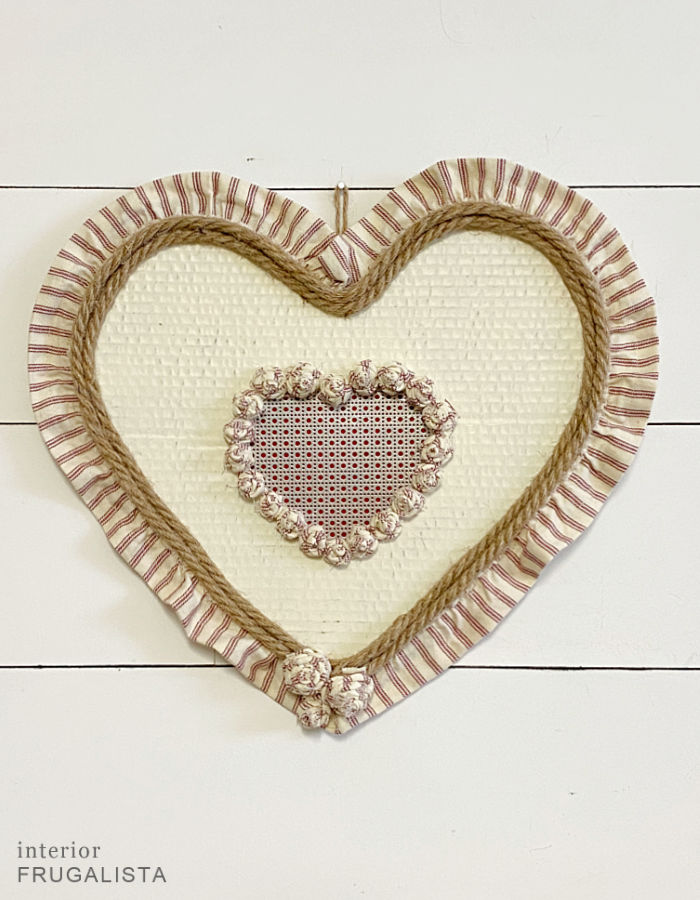 A handmade ticking stripe Valentine wreath that cost nothing to make from recycled materials.