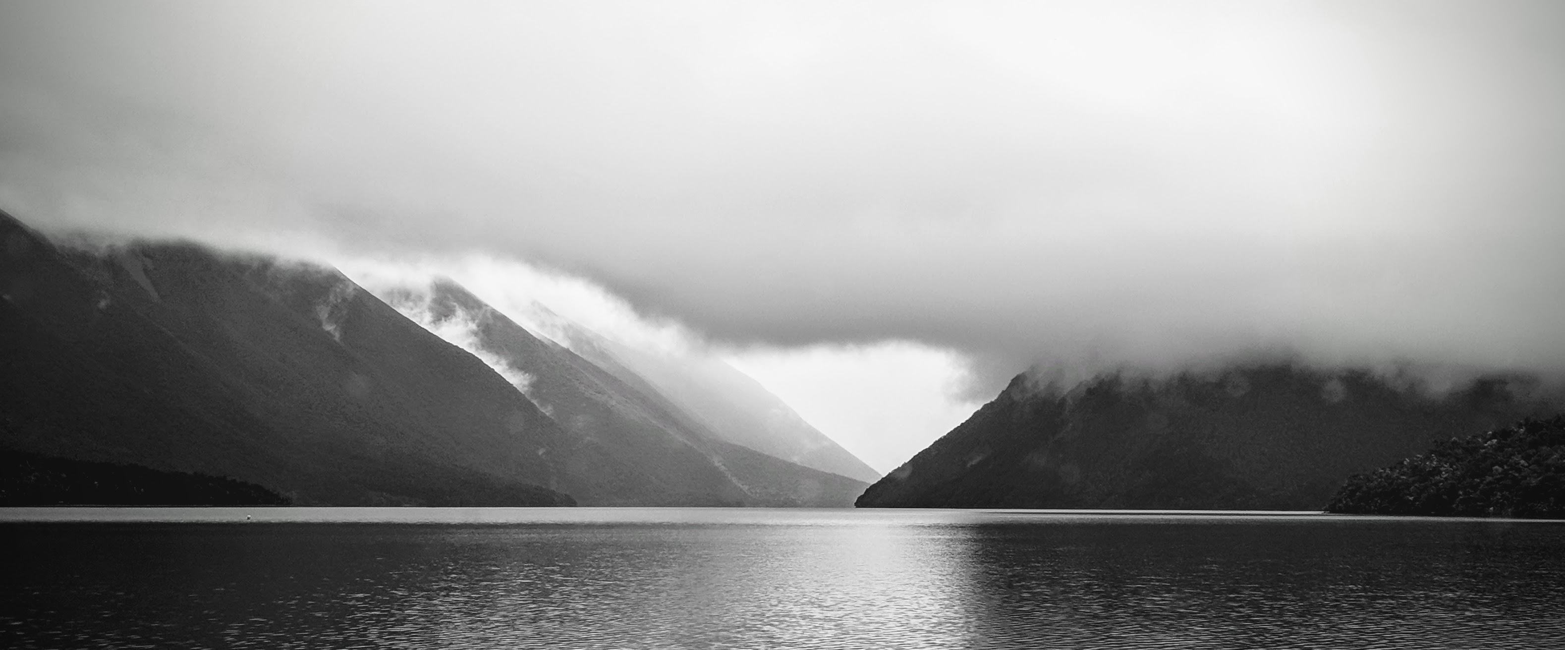 Black and white photo of Lake Rotoiti in low cloud