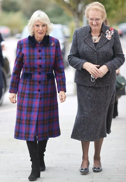 The Duchess wore a bold tartan coat and colour-block scarf, her favourite knee-high boots and Remembrance poppy pin