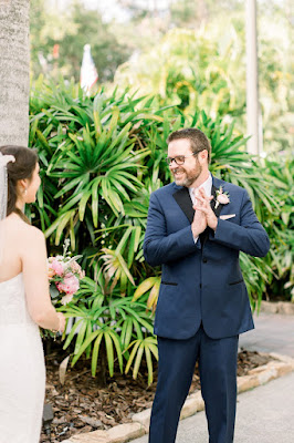 groom seeing bride for the first time and smiling