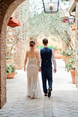 bride and groom holding hands