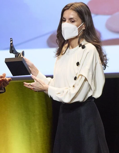 Queen Letizia wore an ecru fontana silk blouse, top from Maksu, and black midi skirt during visit to the Valencia Congress Centre