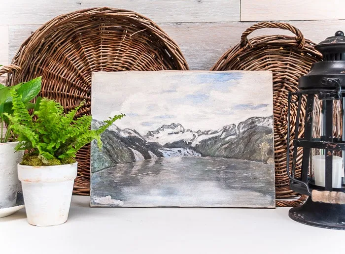 Glacier Bay painting antiqued, styled with baskets, fern