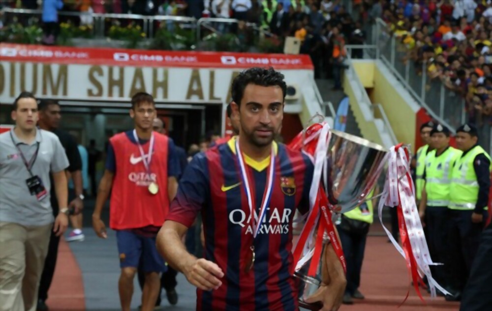 Xavi Hernandez carries the Asia Tour 2013 trophy at the Shah Alam Stadium on August 10, 2013 in Kuala Lumpur, Malaysia defeating Malaysia 3-1.