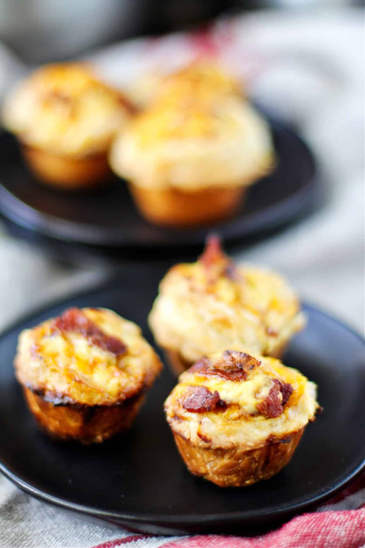 Bacon, Leek, and Cheddar Mini Quiches on plates