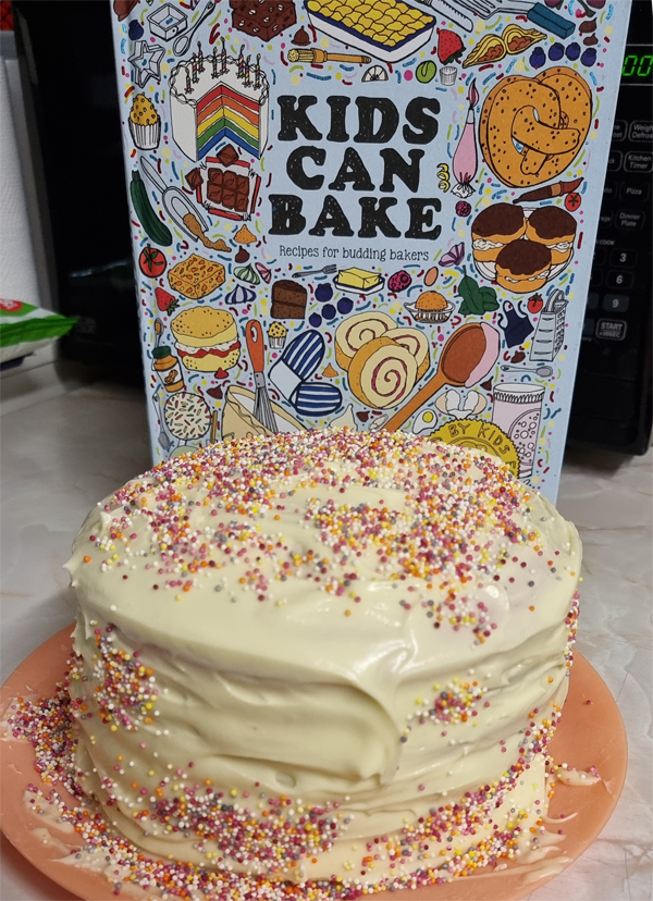 Kids Can Bake Book with a completed Rainbow Cake