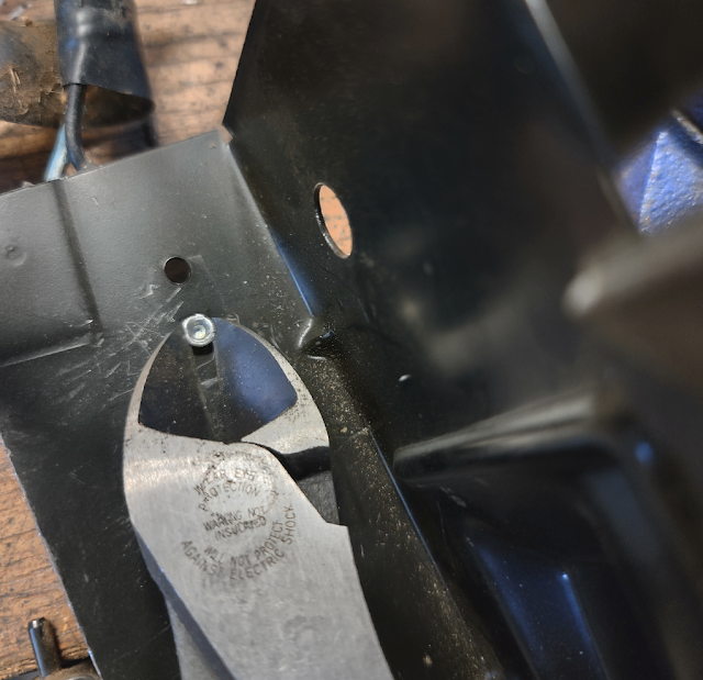 Diagonal cutters being used to remove the guide rivet