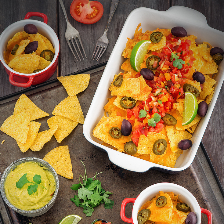 Tortilla chips with Cheddar cheese and tomatos