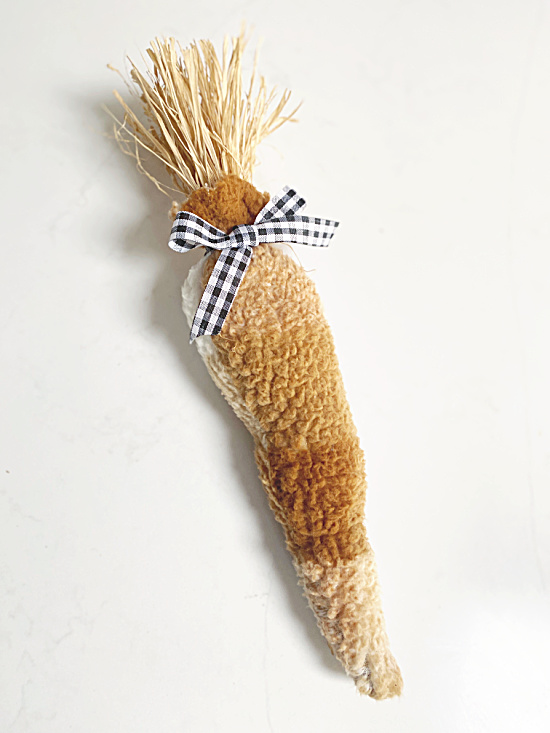 sherpa carrot with raffia top and black and white bow