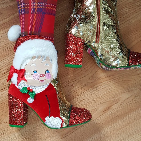 wearing tartan tights and Mrs Claus ankle boot