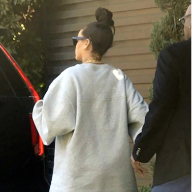 Rihanna is fully covered as she is seen for first time since giving birth (photos)