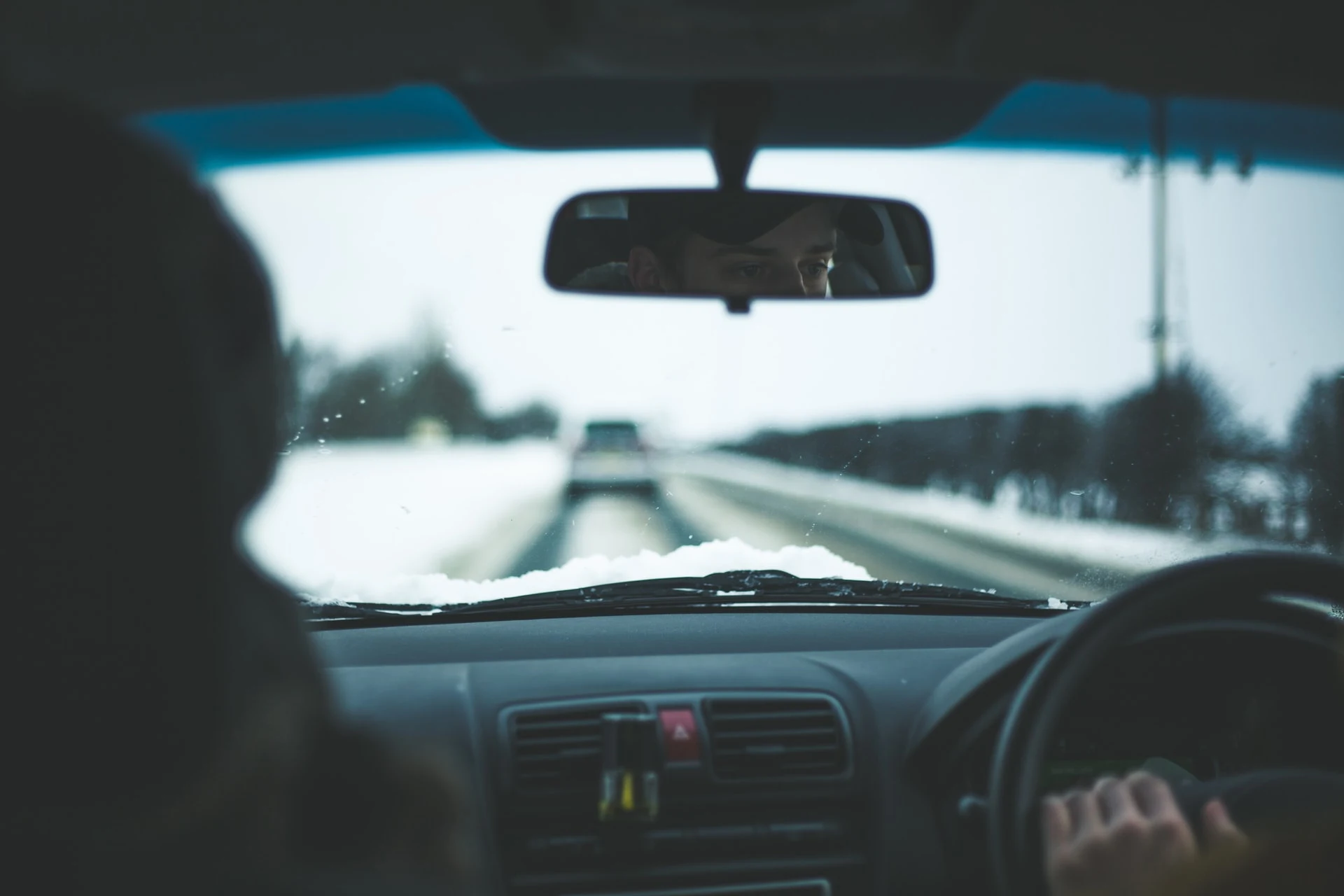 free stock image by Thom Holmes on Unsplash of driving on a snowy road