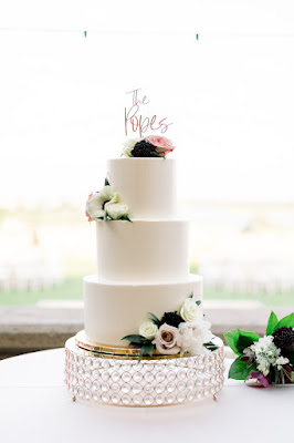 white wedding cake with gold cake topper