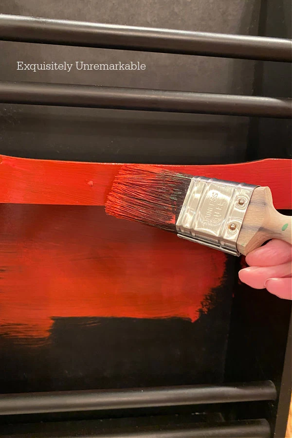 Painting  A Magazine Rack Red with a brush