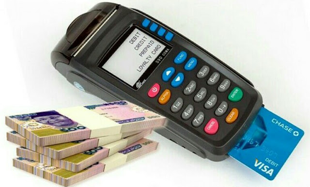 Alt: = "photo showing POS machine and bundles of Naira notes"