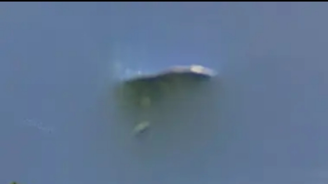 Silver metallic UFO parked in the sky on Google Earth Google Maps.