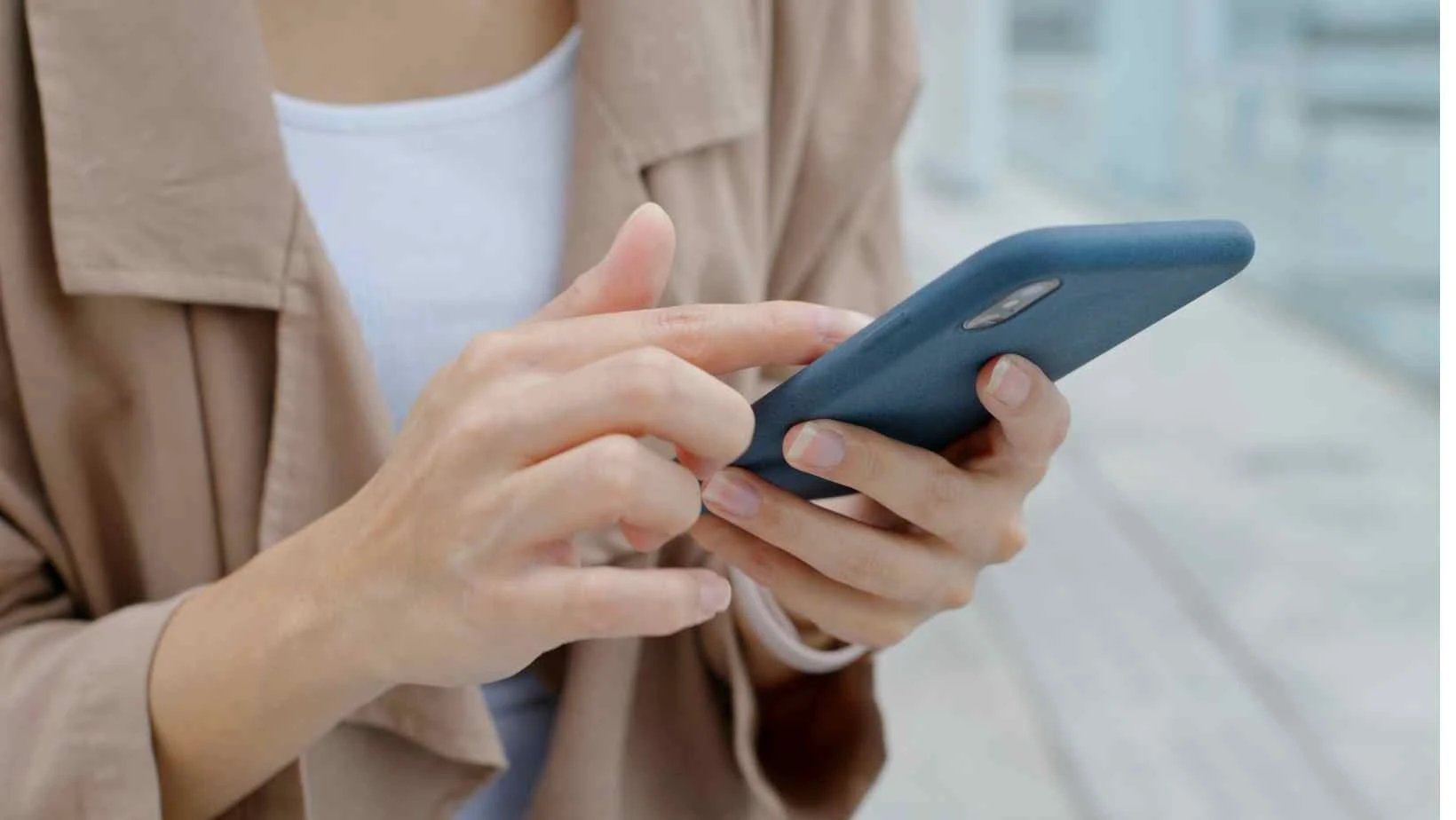 stock image from canva pro of a female scrolling on a smart phone
