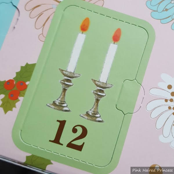 Paul & Joe Makeup Collection 2021 Day 12 candle illustration on door of advent