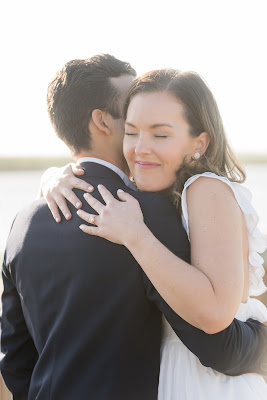 girl hugging guy with engagement ring