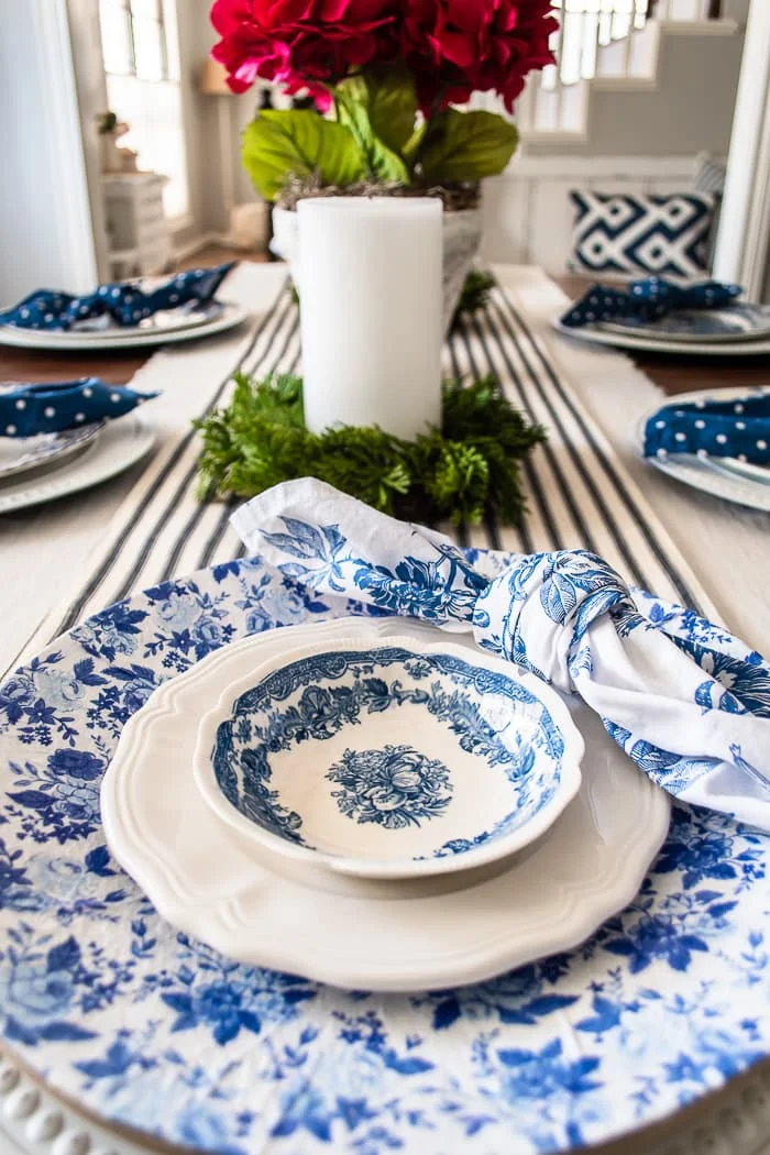 blue and white floral decoupaged charger on Spring table with vintage transferware dishes and ironstone