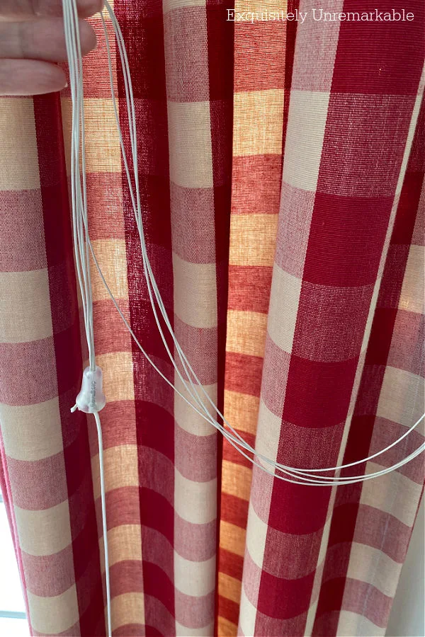 Red Curtains With Blind Strings Draped Across