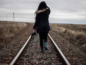 Girl walking in railway