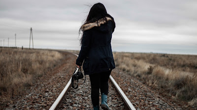 Girl walking in railway