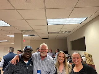 four staff members standing together at happy hour