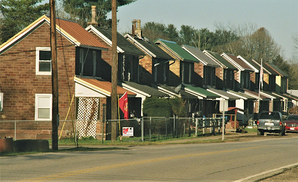 Row of multiple small two story brick houses, all identical in appearance, in the old southeastern Ohio town of Haydenville.