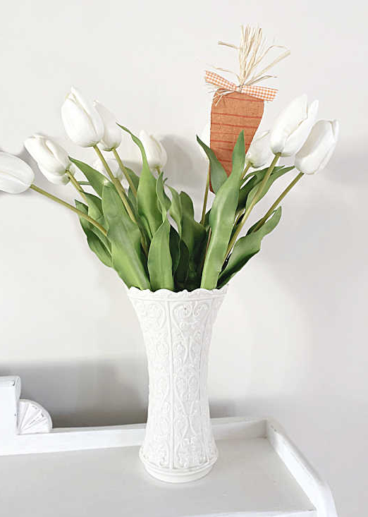vase of tulips and a carrot pick