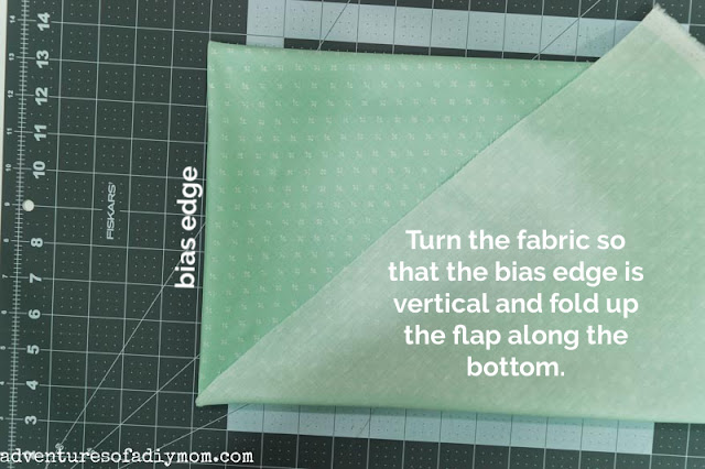folding the fabric along the bias edge
