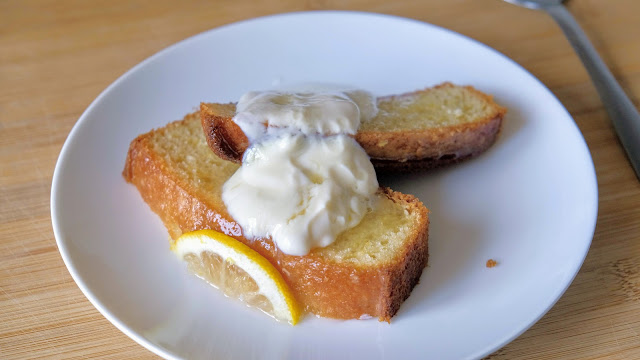 A slice of Vegan Lemon Drizzle Cake on a white plate