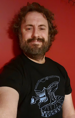 Man with beard in Alien t-shirt