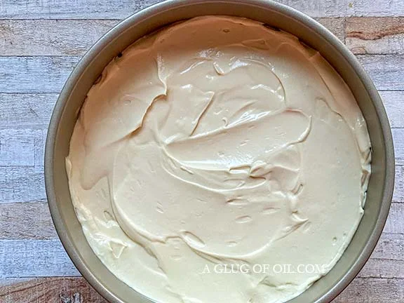 Cheesecake mixture spread over the biscuit base.