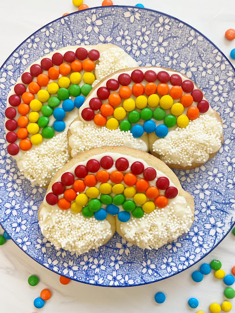 three cookies on a blue and white plate.