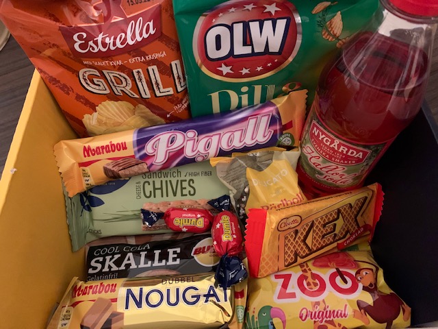An assortment of snacks coming from Sweden, including biscuits, crisps, chocolate